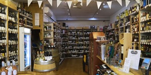 Mill Hill wines inside the store which is full with wines stacked on shelves against the walls 