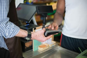 someone paying for an items using a card machine