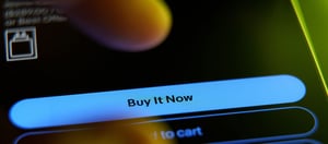 A Finger pressing a blue buy now Button