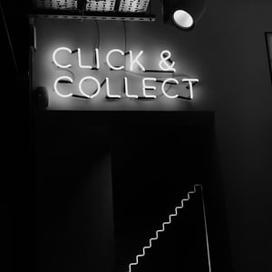 a neon white sign saying Click & Collect