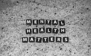 Small Squares each with a letter of Mental Health matters in them