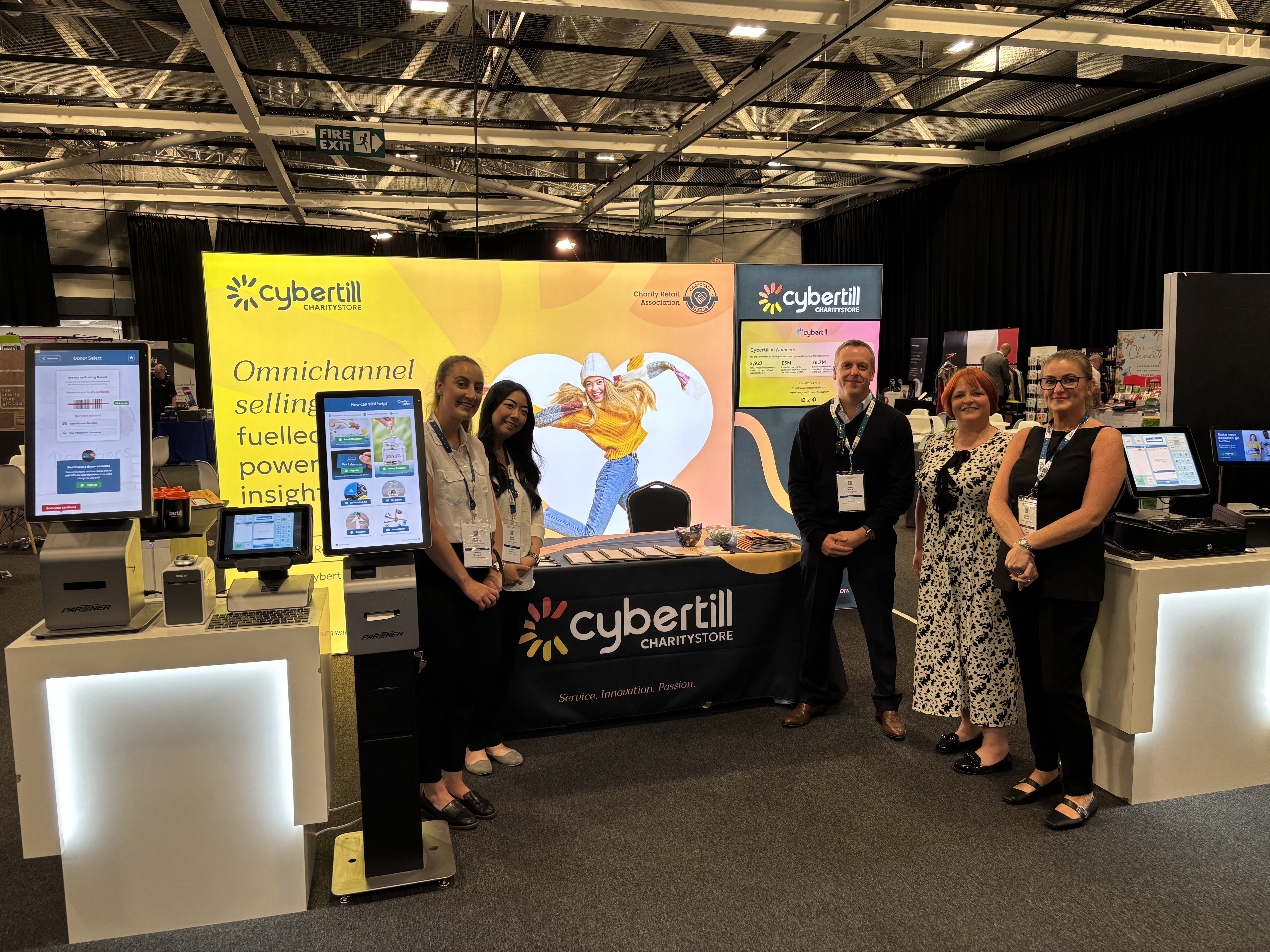 Image of Cybertill's stand at the CRA event with the staff standing next to the stand